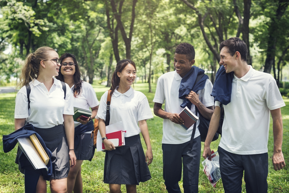 happy-students-walking-through-park